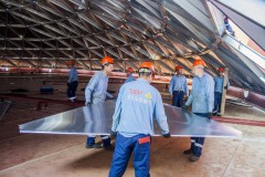 many workers building inside an aluminium dome roof